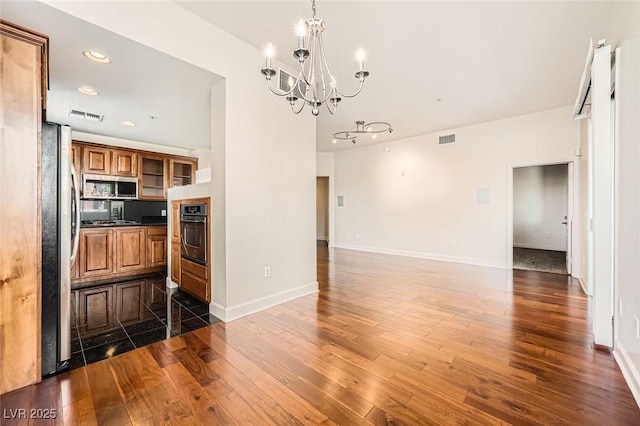 87 E Agate Ave Unit 208, Las Vegas, NV 89123 - kitchen featuring brown cabinetry, a chandelier, dark wood-style floors, dark countertops, and recessed lighting