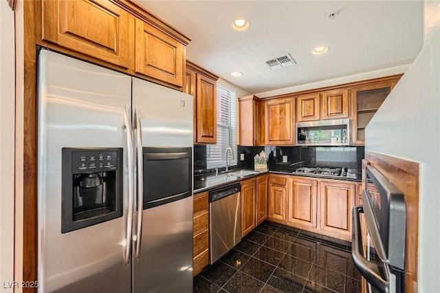 87 E Agate Ave Unit 208, Las Vegas, NV 89123 - kitchen with appliances with stainless steel finishes, recessed lighting, granite tiled floors, brown cabinetry, and backsplash