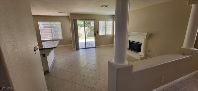 9204 Vosburgh Dr, Las Vegas, NV 89117 - unfurnished living room featuring tile patterned flooring and a glass covered fireplace