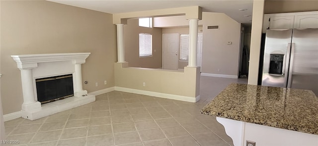 9204 Vosburgh Dr, Las Vegas, NV 89117 - unfurnished living room with decorative columns and a tile fireplace