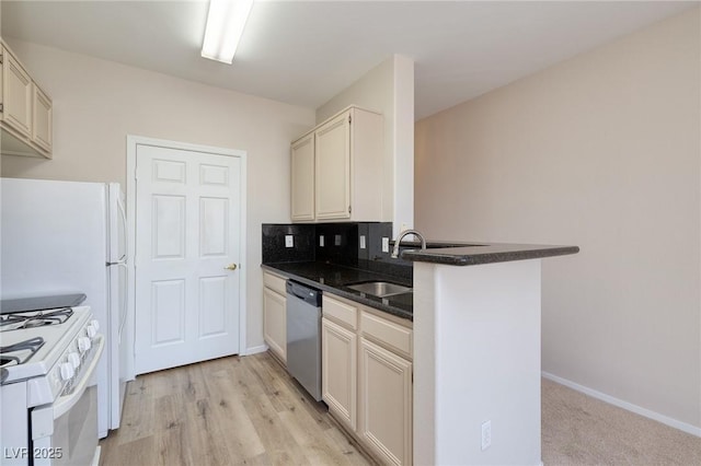 7159 S Durango Dr Unit 310, Las Vegas, NV 89113 - kitchen with stainless steel dishwasher, a peninsula, dark stone countertops, and light wood-style floors