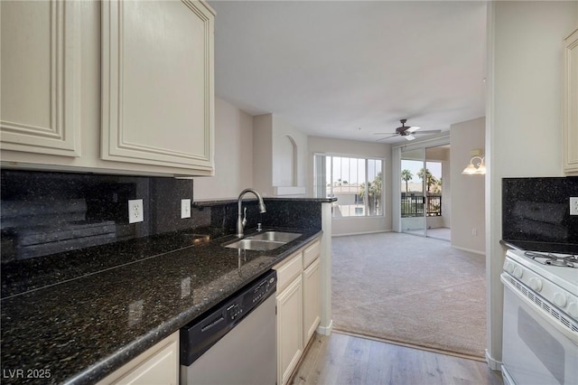 7159 S Durango Dr Unit 310, Las Vegas, NV 89113 - kitchen featuring gas range gas stove, stainless steel dishwasher, a ceiling fan, light carpet, and dark stone counters
