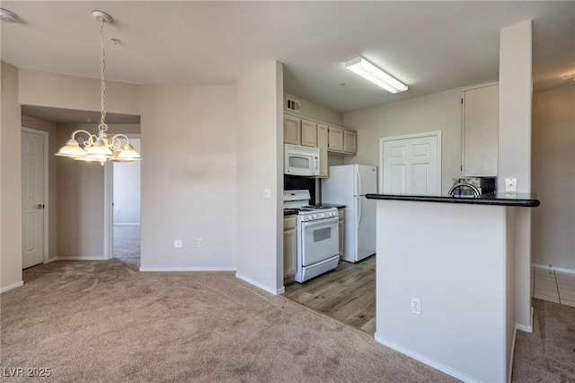 7159 S Durango Dr Unit 310, Las Vegas, NV 89113 - kitchen featuring carpet flooring, a chandelier, white appliances, dark countertops, and a peninsula