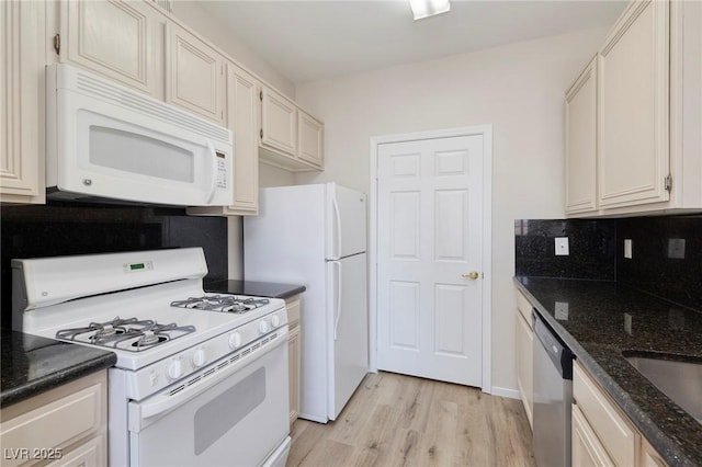 7159 S Durango Dr Unit 310, Las Vegas, NV 89113 - kitchen with white appliances, light wood finished floors, dark stone countertops, and backsplash