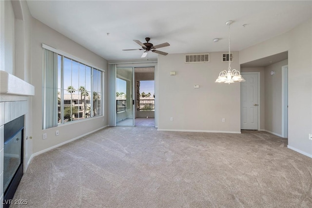 7159 S Durango Dr Unit 310, Las Vegas, NV 89113 - unfurnished living room featuring carpet, a glass covered fireplace, a chandelier, and ceiling fan