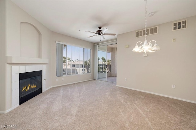 7159 S Durango Dr Unit 310, Las Vegas, NV 89113 - unfurnished living room featuring carpet, a tile fireplace, a chandelier, and a ceiling fan