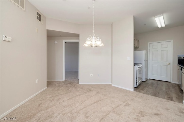 7159 S Durango Dr Unit 310, Las Vegas, NV 89113 - unfurnished dining area with a chandelier and light carpet