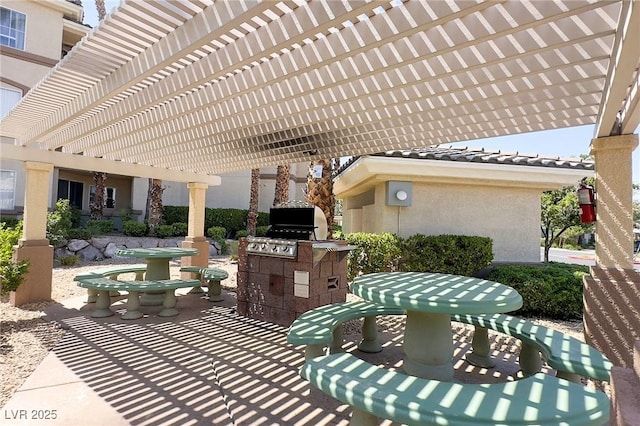 7159 S Durango Dr Unit 310, Las Vegas, NV 89113 - view of patio featuring a pergola and an outdoor kitchen
