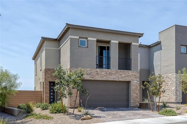 9827 Mojave Mountain St, Las Vegas, NV 89166 - modern home featuring a balcony, a garage, stucco siding, and driveway