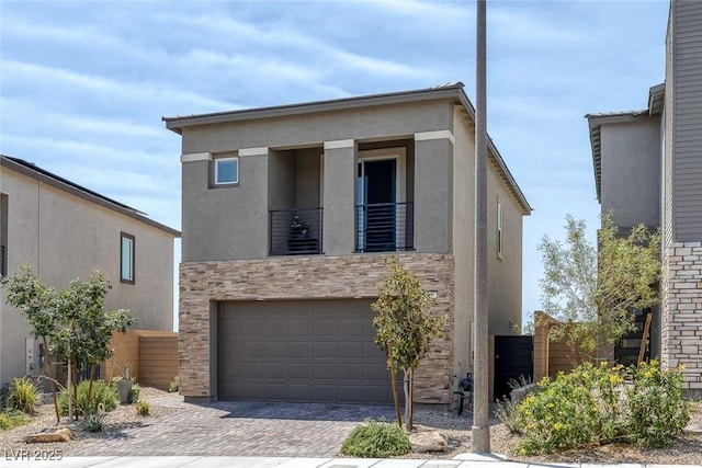 9827 Mojave Mountain St, Las Vegas, NV 89166 - contemporary house with a garage, driveway, a balcony, stucco siding, and stone siding