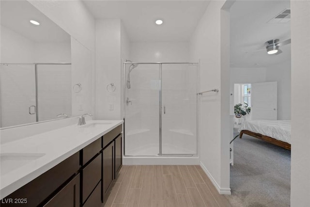 9827 Mojave Mountain St, Las Vegas, NV 89166 - ensuite bathroom featuring a stall shower, double vanity, recessed lighting, ceiling fan, and wood finished floors