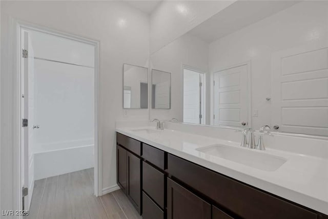 9827 Mojave Mountain St, Las Vegas, NV 89166 - bathroom featuring double vanity and wood finished floors