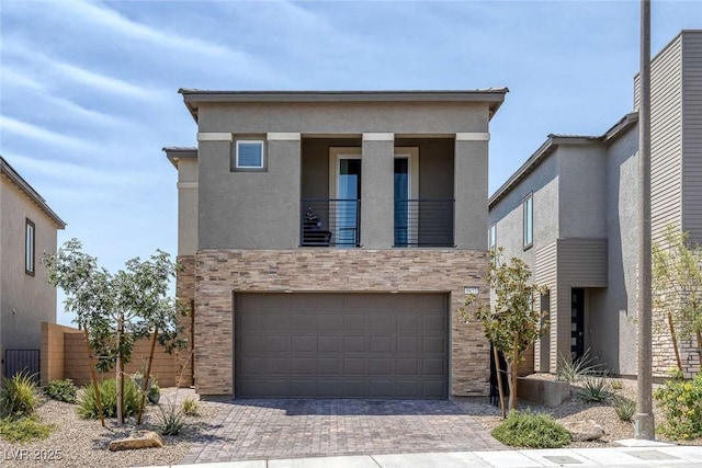 9827 Mojave Mountain St, Las Vegas, NV 89166 - modern home featuring a garage, driveway, stucco siding, and a balcony