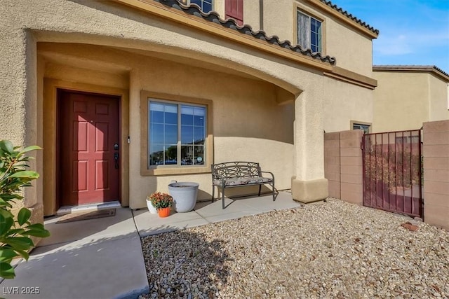 9916 Fallowdeer Ct, Las Vegas, NV 89149 - doorway to property featuring stucco siding, a tiled roof, and a gate