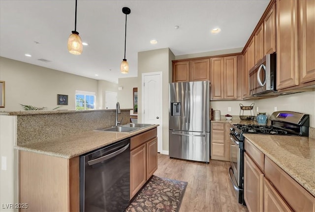 9916 Fallowdeer Ct, Las Vegas, NV 89149 - kitchen featuring stainless steel appliances, light wood-type flooring, decorative light fixtures, light stone countertops, and recessed lighting