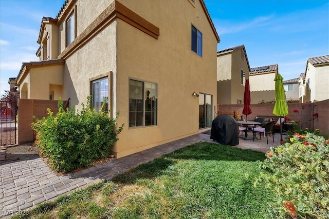9916 Fallowdeer Ct, Las Vegas, NV 89149 - rear view of house featuring stucco siding, a patio area, and a tile roof