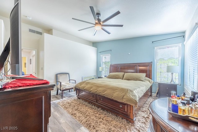 7824 Indian Cloud Ave, Las Vegas, NV 89129 - bedroom with light wood-style floors, multiple windows, and a ceiling fan