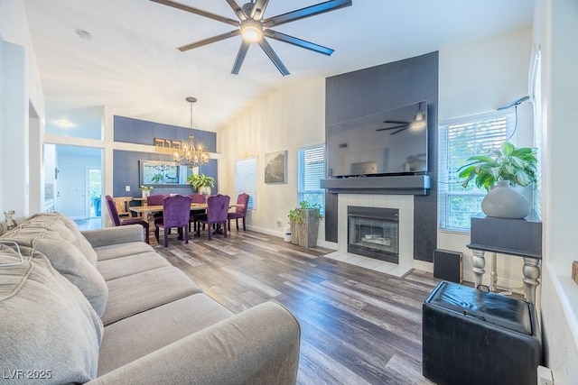 7824 Indian Cloud Ave, Las Vegas, NV 89129 - living room with ceiling fan, a chandelier, wood finished floors, a fireplace, and high vaulted ceiling