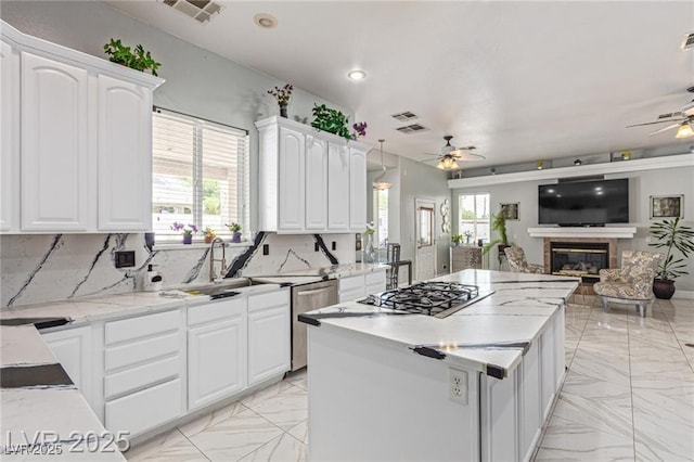 60 N Fogg St, Las Vegas, NV 89110 - kitchen with ceiling fan, light marble finish floors, open floor plan, a kitchen island, and recessed lighting