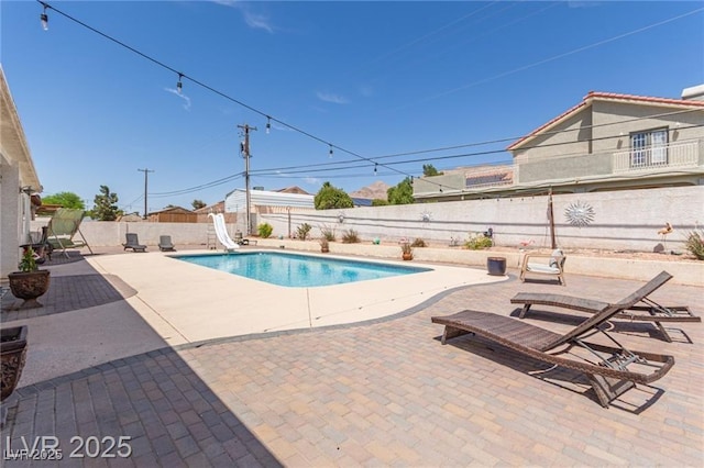 60 N Fogg St, Las Vegas, NV 89110 - view of pool featuring a water slide, a fenced backyard, and a patio
