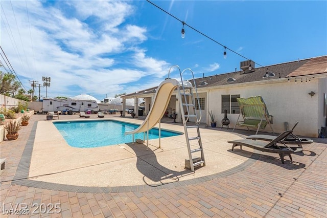 60 N Fogg St, Las Vegas, NV 89110 - view of swimming pool featuring a water slide, a patio area, and a fenced backyard