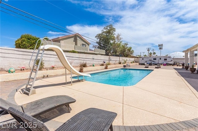 60 N Fogg St, Las Vegas, NV 89110 - view of pool with a water slide, a patio, and a fenced backyard