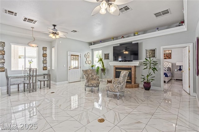 60 N Fogg St, Las Vegas, NV 89110 - living room with ceiling fan, light marble finish floors, and a tiled fireplace