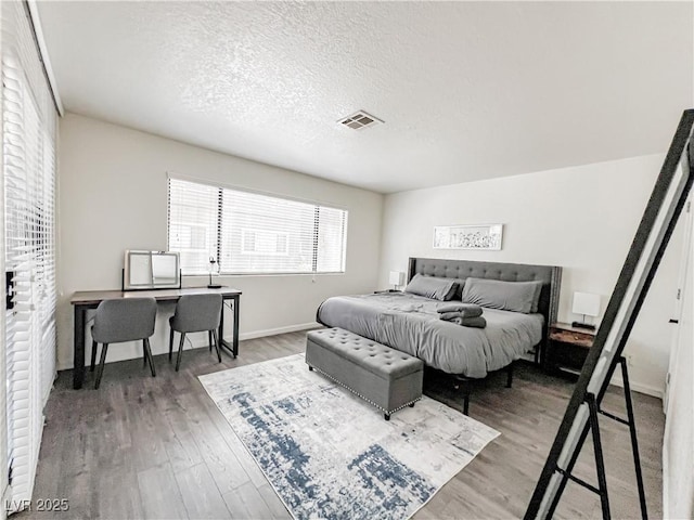 5042 S Rainbow Blvd Unit 103, Las Vegas, NV 89118 - bedroom featuring wood finished floors, a desk, and a textured ceiling