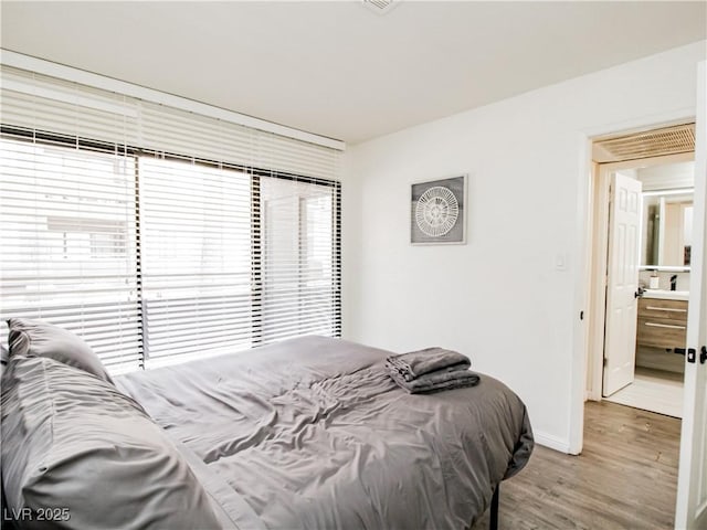 5042 S Rainbow Blvd Unit 103, Las Vegas, NV 89118 - bedroom with wood finished floors and baseboards