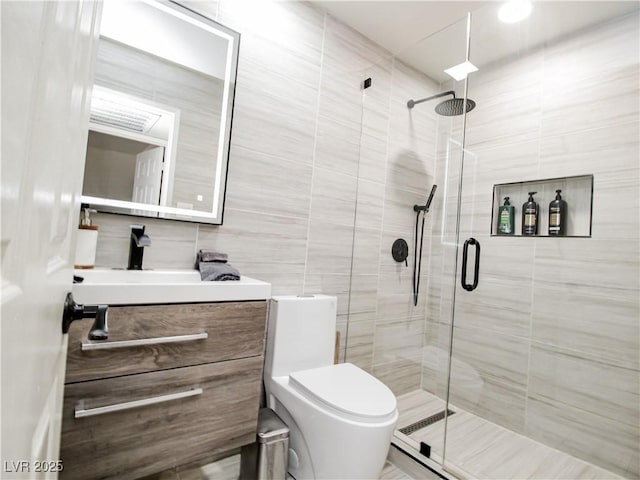 5042 S Rainbow Blvd Unit 103, Las Vegas, NV 89118 - bathroom featuring a stall shower, vanity, and tile walls