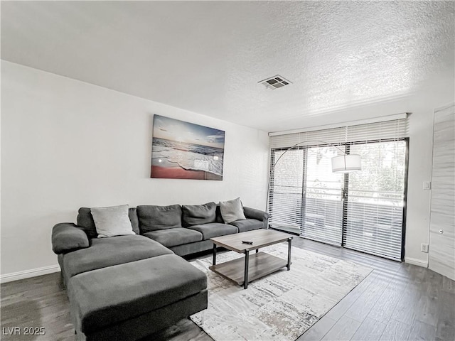 5042 S Rainbow Blvd Unit 103, Las Vegas, NV 89118 - living area featuring a textured ceiling and wood finished floors