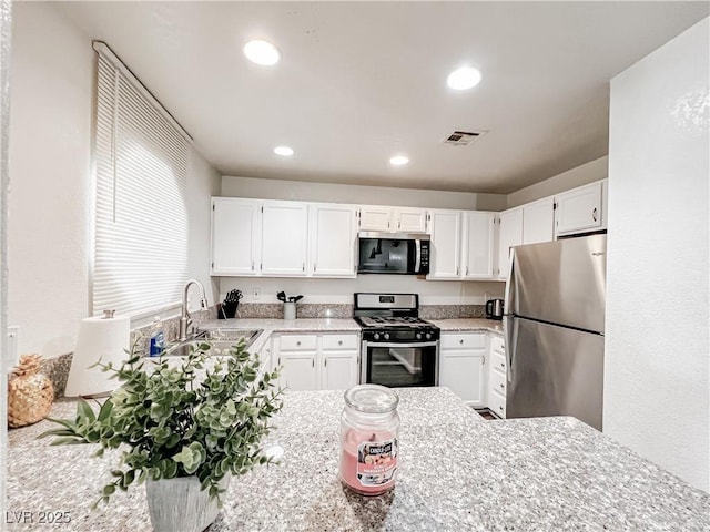 5042 S Rainbow Blvd Unit 103, Las Vegas, NV 89118 - kitchen with appliances with stainless steel finishes, white cabinets, and recessed lighting