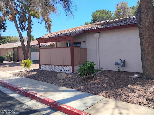 425 N Lamb Blvd Unit D, Las Vegas, NV 89110 - view of side of property featuring stucco siding and a tiled roof