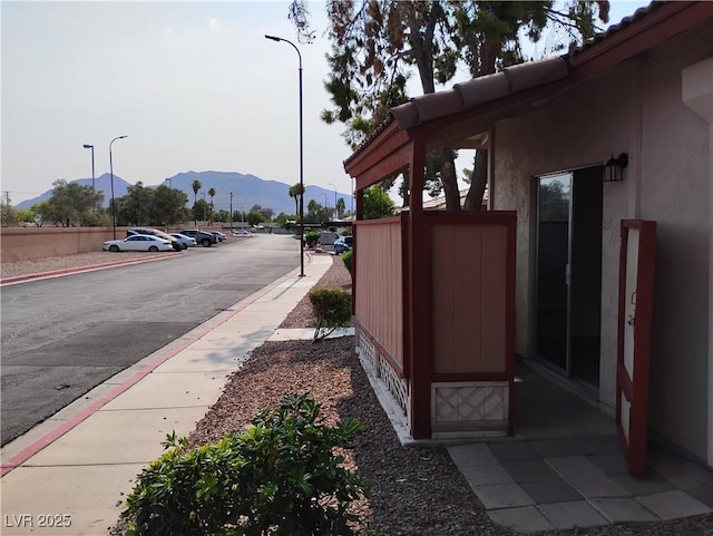 425 N Lamb Blvd Unit D, Las Vegas, NV 89110 - view of asphalt road with a mountain view, sidewalks, street lights, and curbs