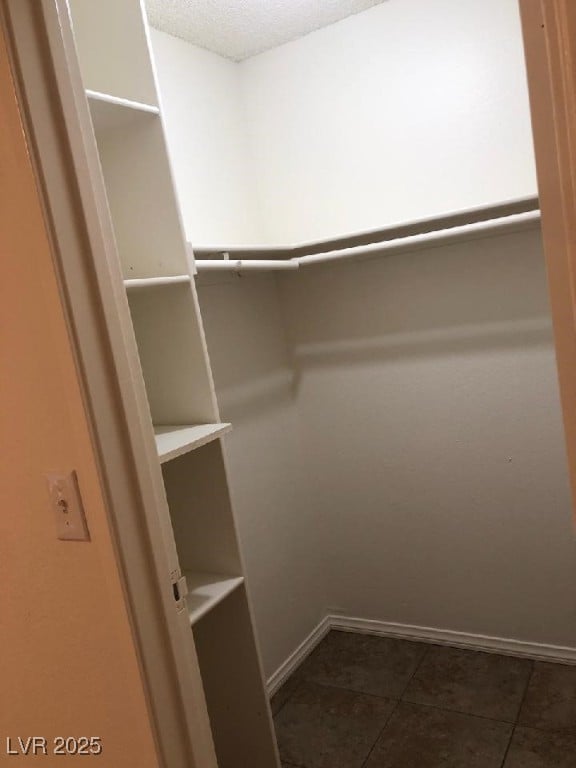 425 N Lamb Blvd Unit D, Las Vegas, NV 89110 - spacious closet featuring dark tile patterned floors