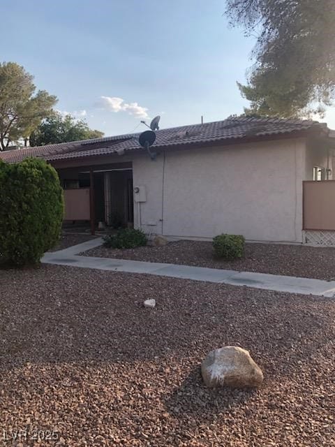 425 N Lamb Blvd Unit D, Las Vegas, NV 89110 - view of home's exterior featuring a tiled roof and stucco siding