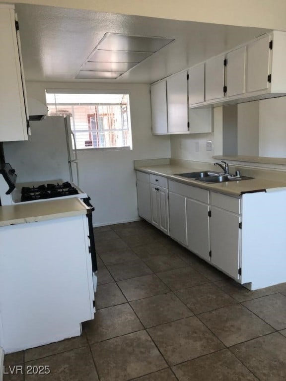425 N Lamb Blvd Unit D, Las Vegas, NV 89110 - kitchen featuring white appliances, dark tile patterned flooring, white cabinets, and light countertops