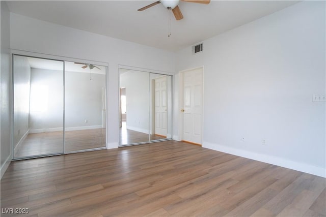 9580 W Reno Ave Unit 240, Las Vegas, NV 89148 - unfurnished bedroom with two closets, wood finished floors, and ceiling fan