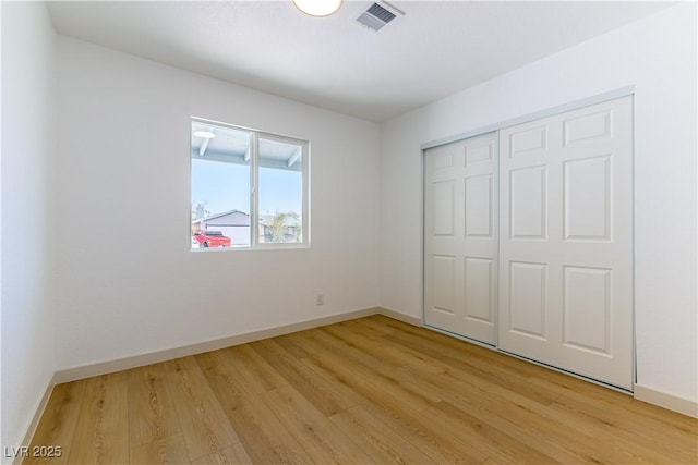 6760 Fallona Ave, Las Vegas, NV 89156 - unfurnished bedroom with light wood-type flooring and a closet