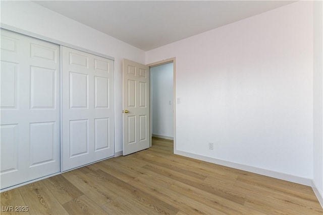 6760 Fallona Ave, Las Vegas, NV 89156 - unfurnished bedroom with light wood finished floors and a closet