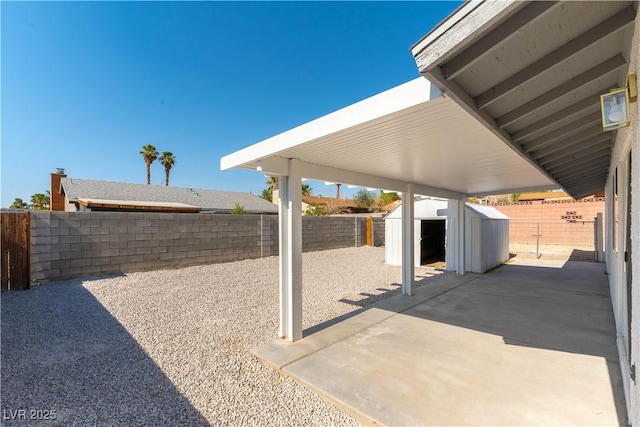 6760 Fallona Ave, Las Vegas, NV 89156 - fenced backyard featuring a storage shed and a patio area