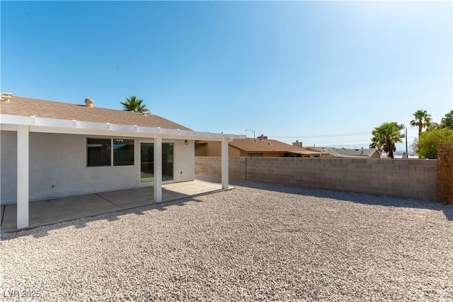 6760 Fallona Ave, Las Vegas, NV 89156 - back of property with stucco siding and a patio