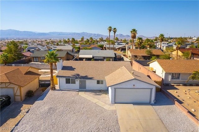 6760 Fallona Ave, Las Vegas, NV 89156 - view of front of home with a residential view, concrete driveway, a mountain view, and stucco siding