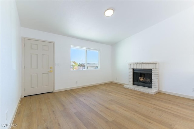 6760 Fallona Ave, Las Vegas, NV 89156 - unfurnished living room with light wood-style floors and a fireplace