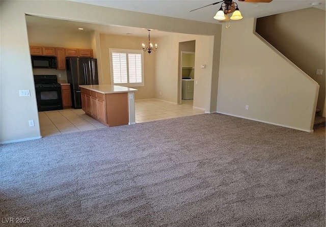 2648 Blairgowrie Dr, Henderson, NV 89044 - kitchen with a ceiling fan, black appliances, a chandelier, and light carpet