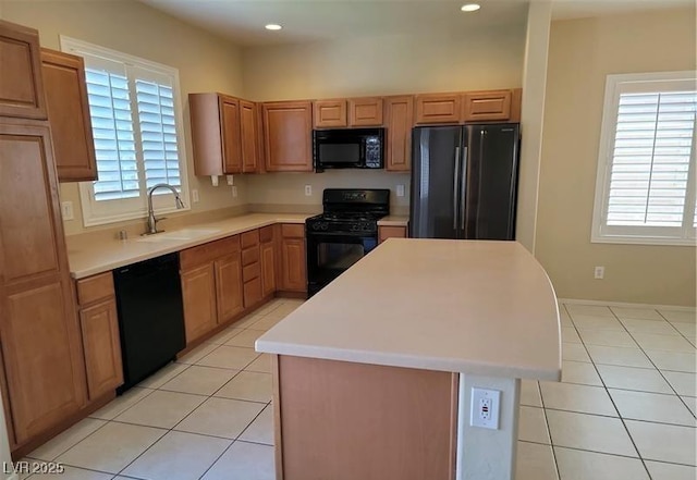 2648 Blairgowrie Dr, Henderson, NV 89044 - kitchen with black appliances, a center island, plenty of natural light, light countertops, and recessed lighting
