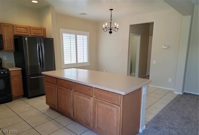 2648 Blairgowrie Dr, Henderson, NV 89044 - kitchen featuring black appliances, light tile patterned floors, a chandelier, light countertops, and pendant lighting
