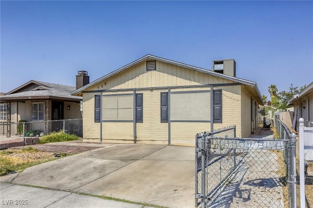 729 Concrete Ct, Las Vegas, NV 89110 - view of front of home featuring brick siding, a gate, and a chimney