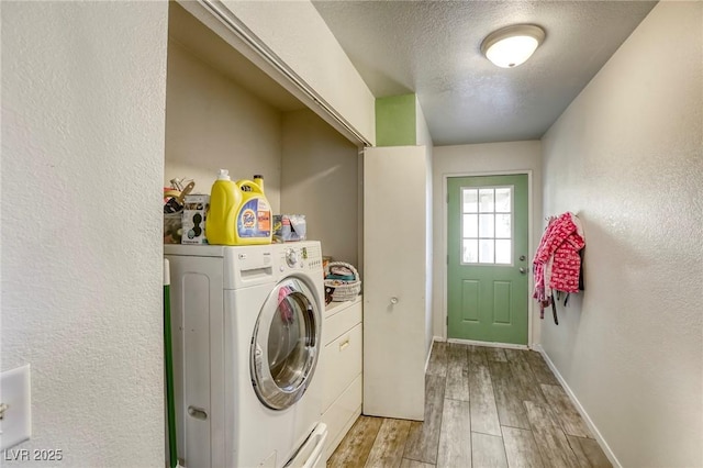 729 Concrete Ct, Las Vegas, NV 89110 - washroom featuring light wood-style floors, a textured ceiling, washer and clothes dryer, and a textured wall