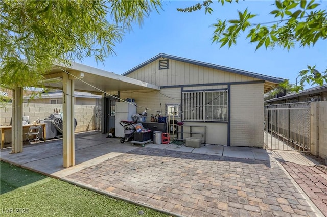 729 Concrete Ct, Las Vegas, NV 89110 - rear view of property featuring a patio, a gate, and brick siding